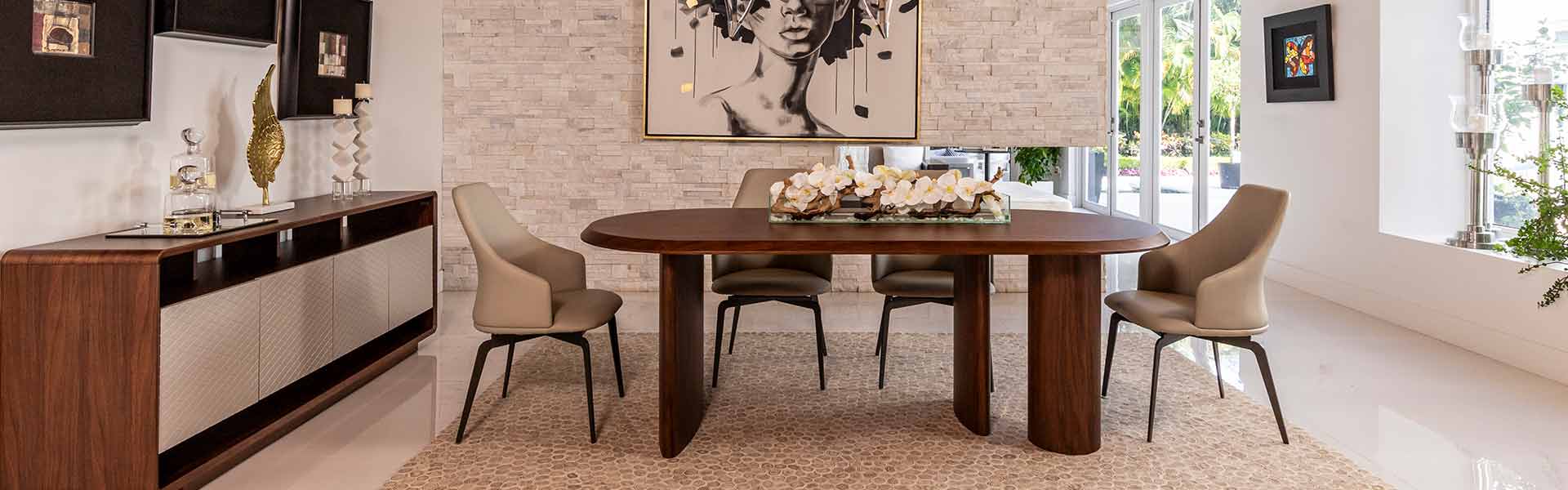 Elegant dining room setup with a rounded walnut table, gray upholstered chairs, and a modern sideboard under a monochrome portrait Artwork.